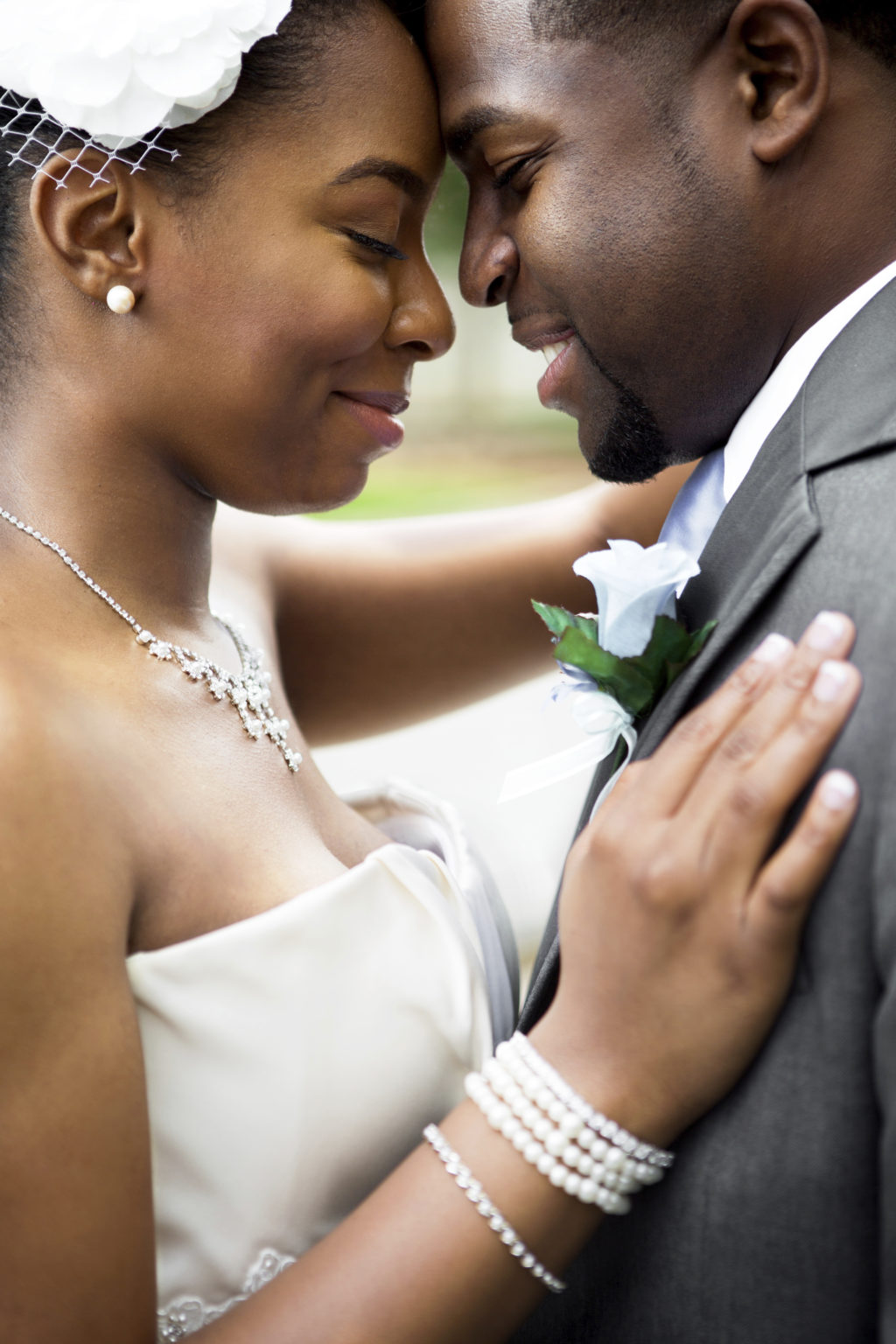 Newlyweds touching foreheads and smiling