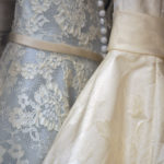 Rack of pretty bridesmaids dresses in ivory and blue