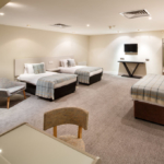 Double bed and two single beds in a family room at the mercure hull grange park hotel