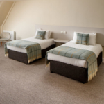 Double bed and two single beds in a family room at the mercure hull grange park hotel