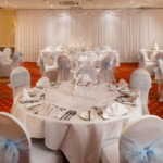 Tables set for a blue wedding theme in the garden suite at the mercure hull grange park hotel