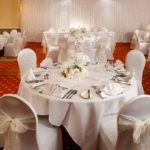 Tables set for an ivory wedding theme in the garden suite at the mercure hull grange park hotel