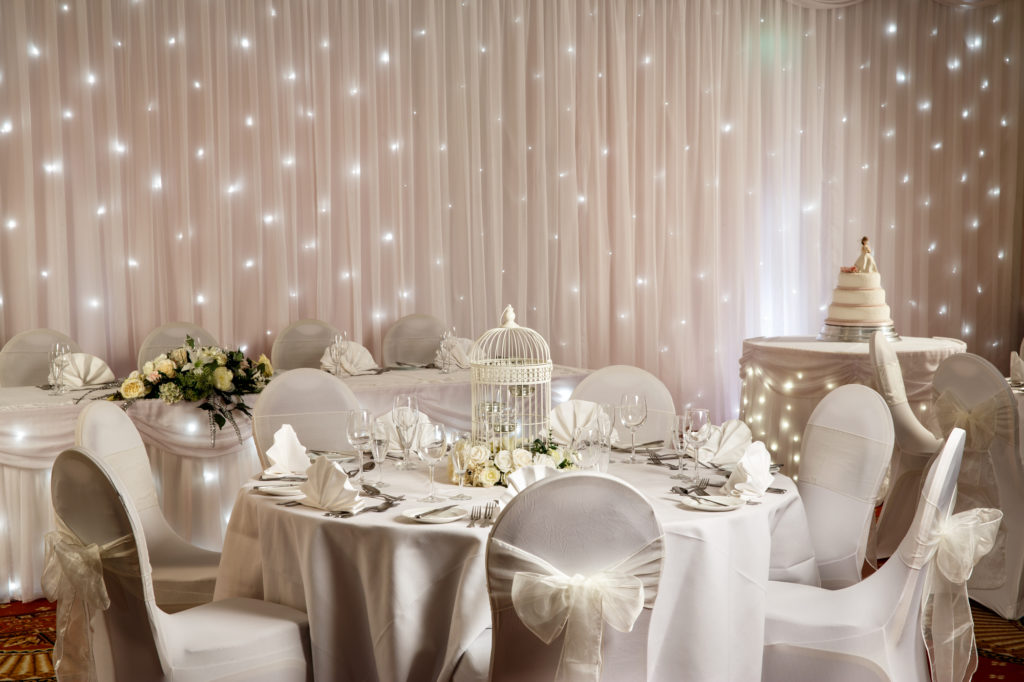 Close up of tables set for an ivory wedding theme in the garden suite at the mercure hull grange park hotel
