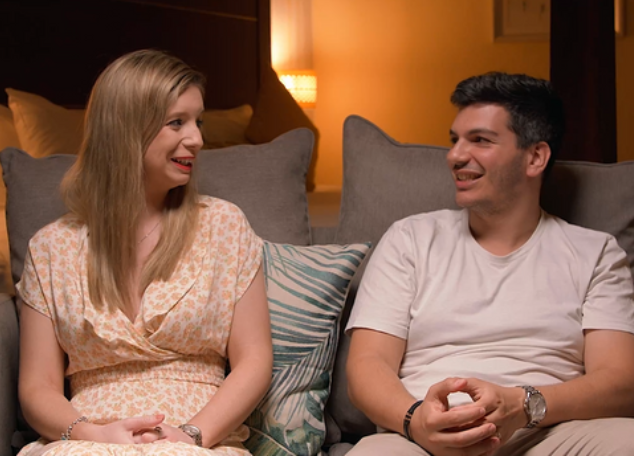 Couple having a conversation on sofa